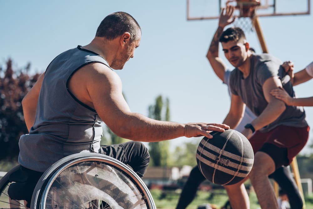 man in wheelchair playing basketball