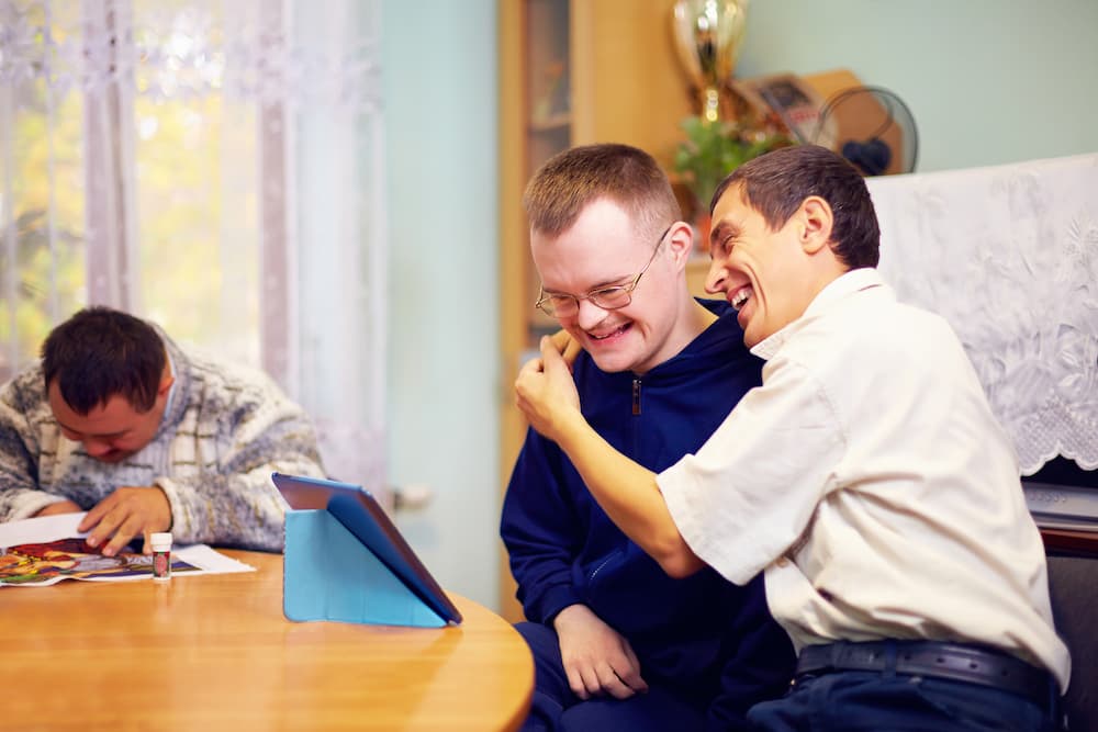 happy friends with disability socializing through internet