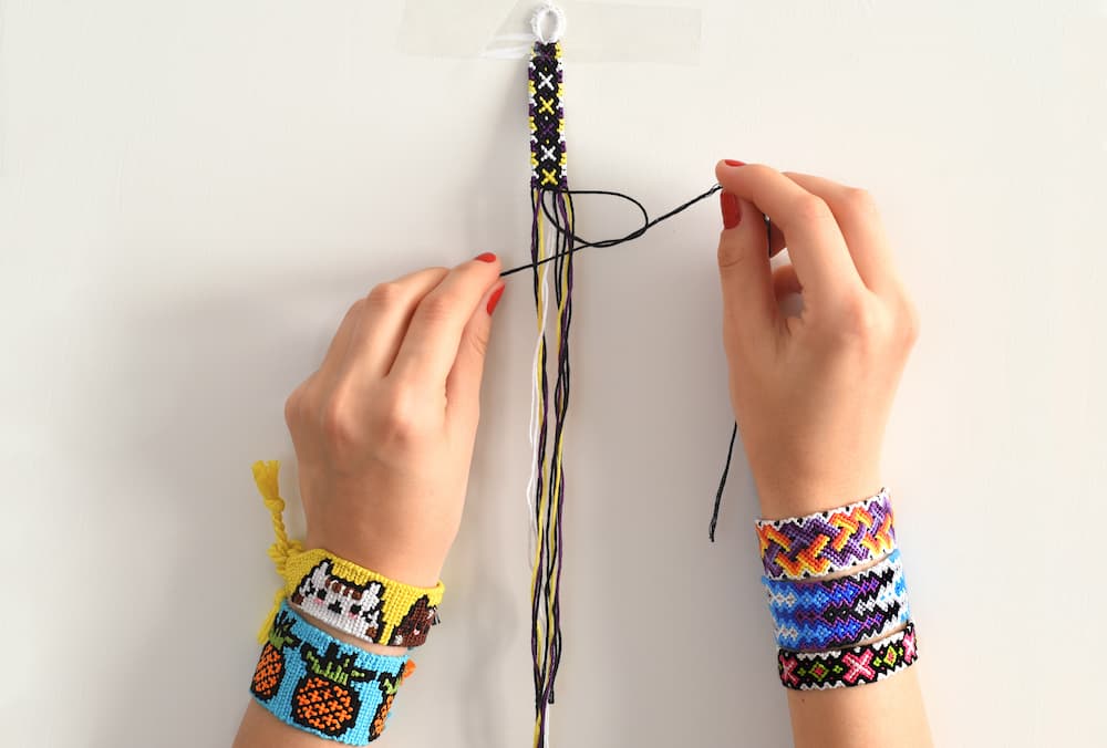 Process of weaving knot for DIY friendship bracelet