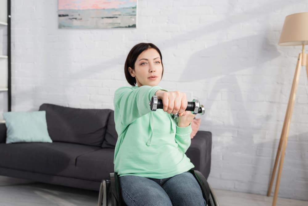 Dumbbell in hand of displeased woman