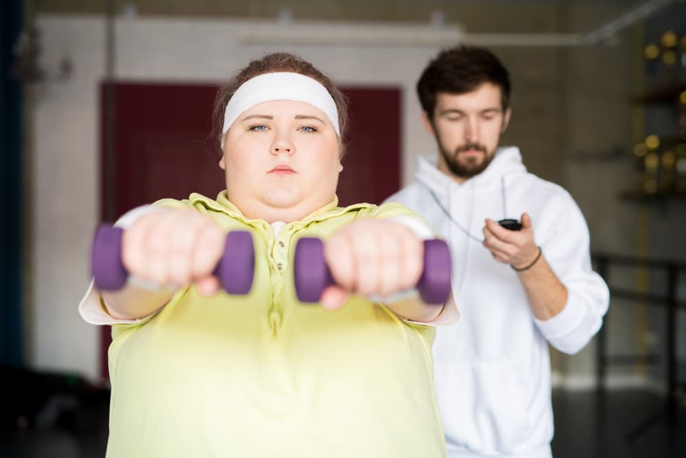 Front view portrait of motivated overweight woman working out