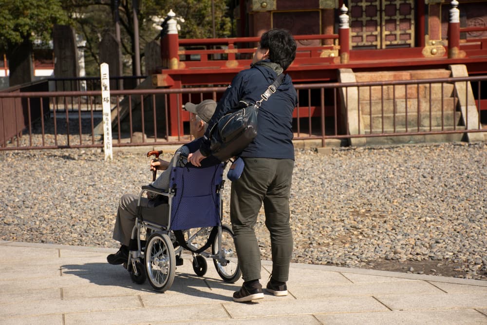 Japanese family people push wheelchair