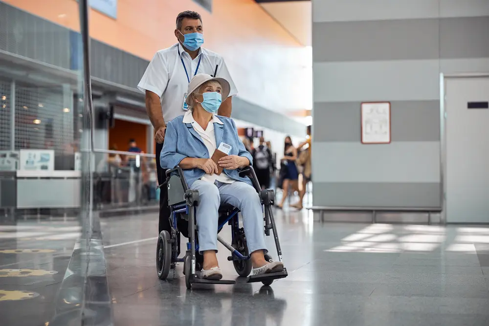 Elderly female passenger being transported in a wheelchair