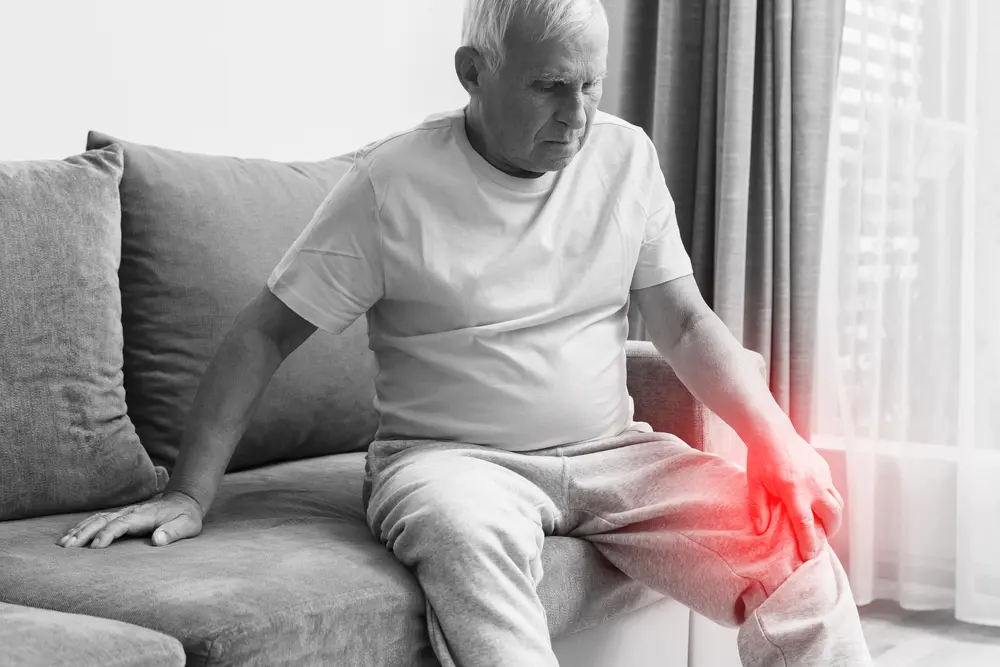 Senior man suffering from pain in his knee