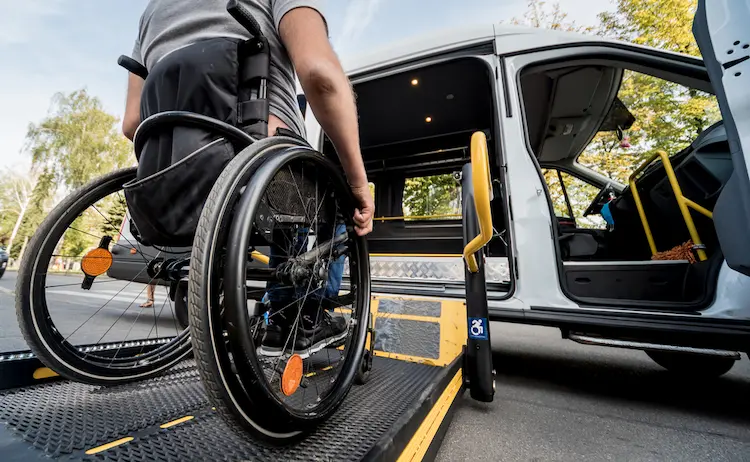 A-man-in-a-wheelchair-moves-to-the-lift-of-a-specialized-vehicle