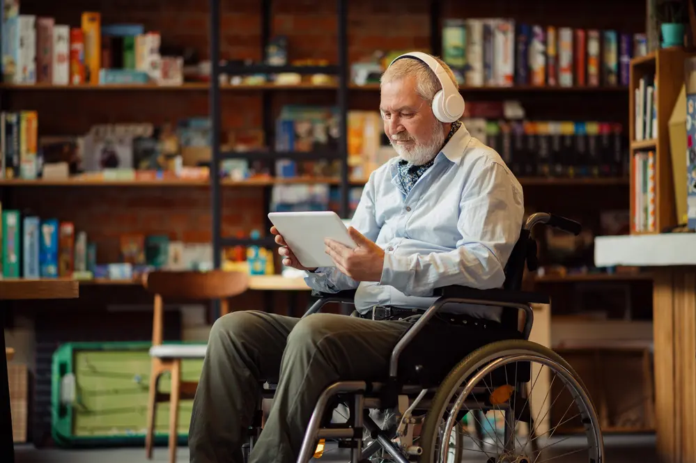 Adult disabled man in wheelchair listen to music
