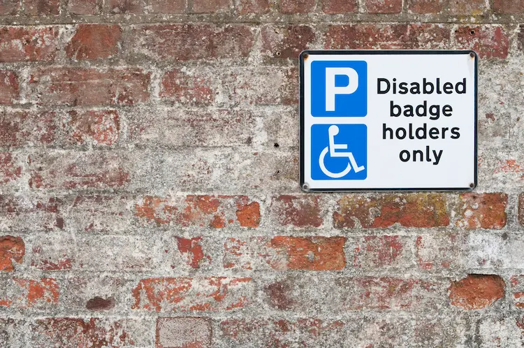 Disabled parking space plate on brick wall