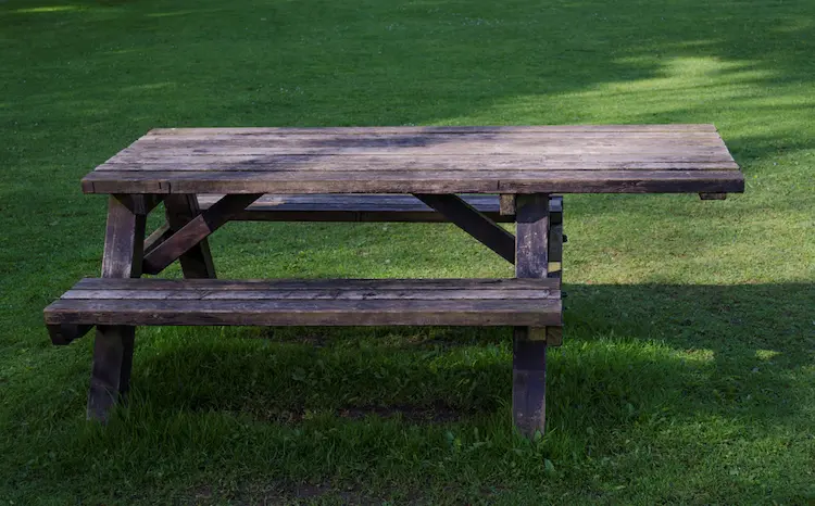 A wooden picnic table with integrated seating