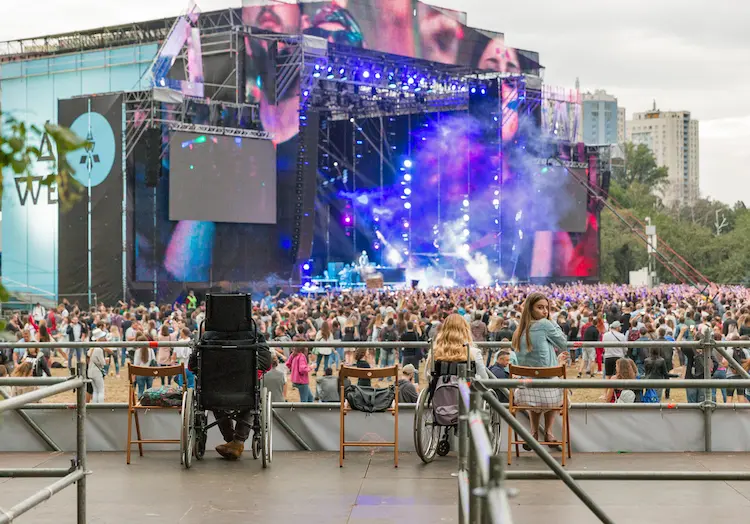 Disabled people in wheelchair watching a concert